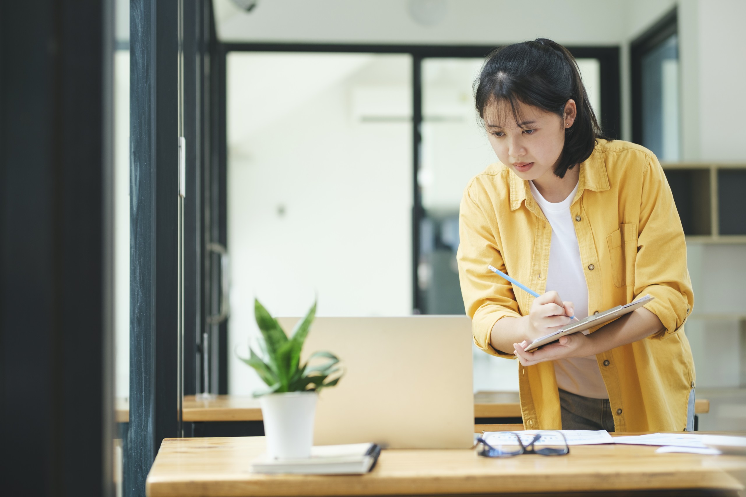 Young asian business woman or student working online on computer